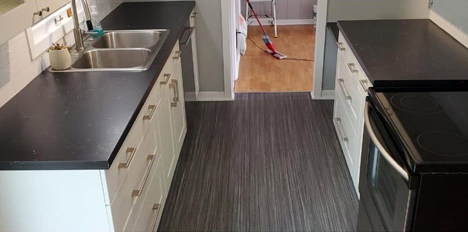 The same kitchen after a CCR clean, counters wiped clear and the floor mopped