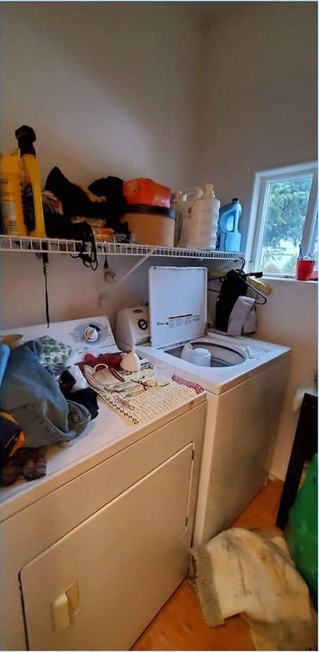 A laundry room before a CCR clean, laundry and household items piled on the machines
