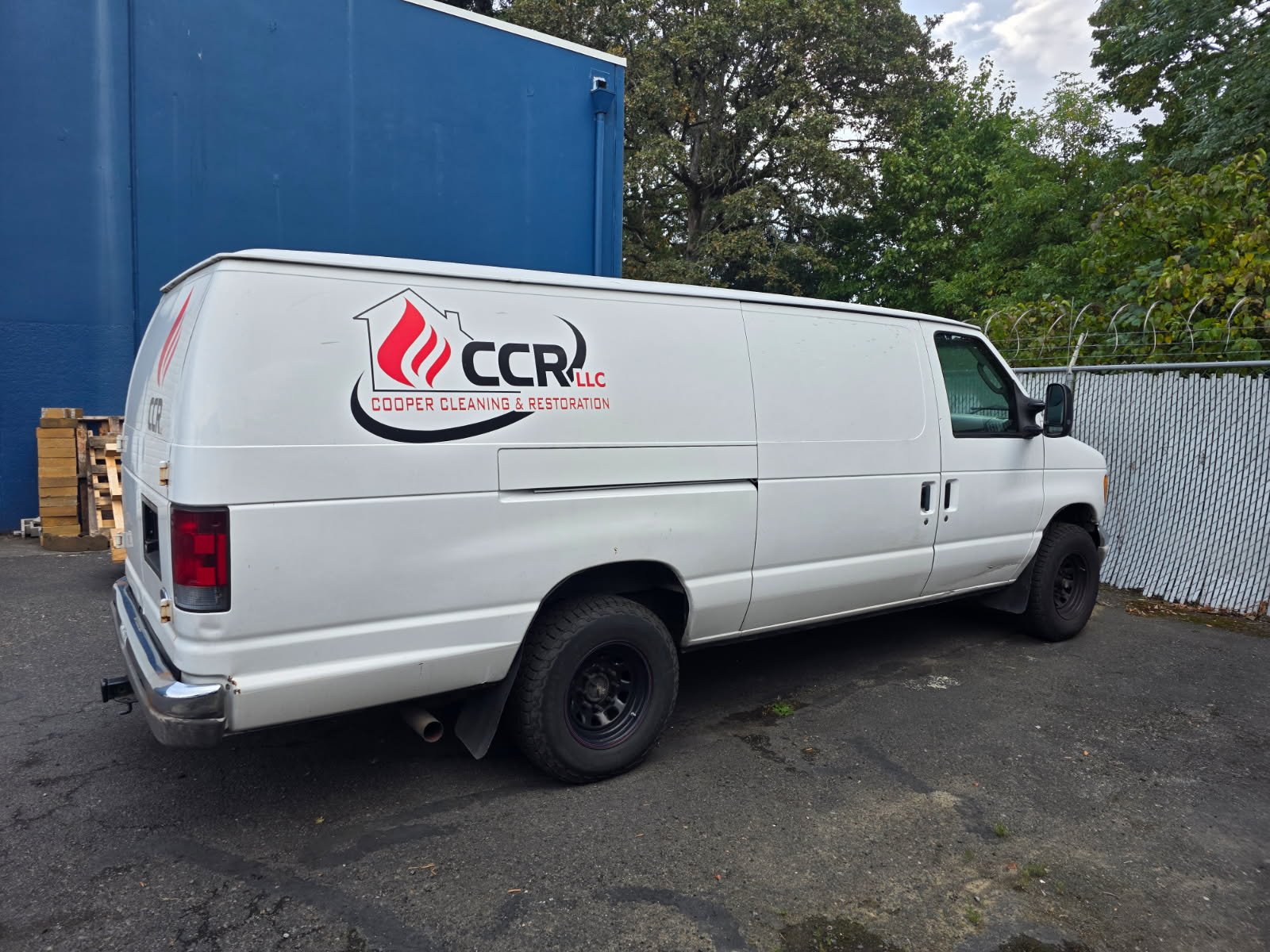 A white CCR cargo van with the company logo on the side