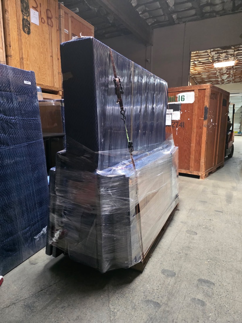 A wrapped and strapped load beside numbered timber storage vaults in CCR&rsquo;s Vancouver warehouse