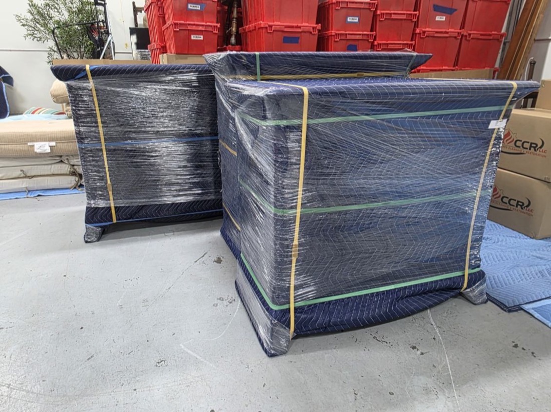 Two pieces padded, wrapped and banded, tagged, beside CCR&rsquo;s red inventory totes and boxes